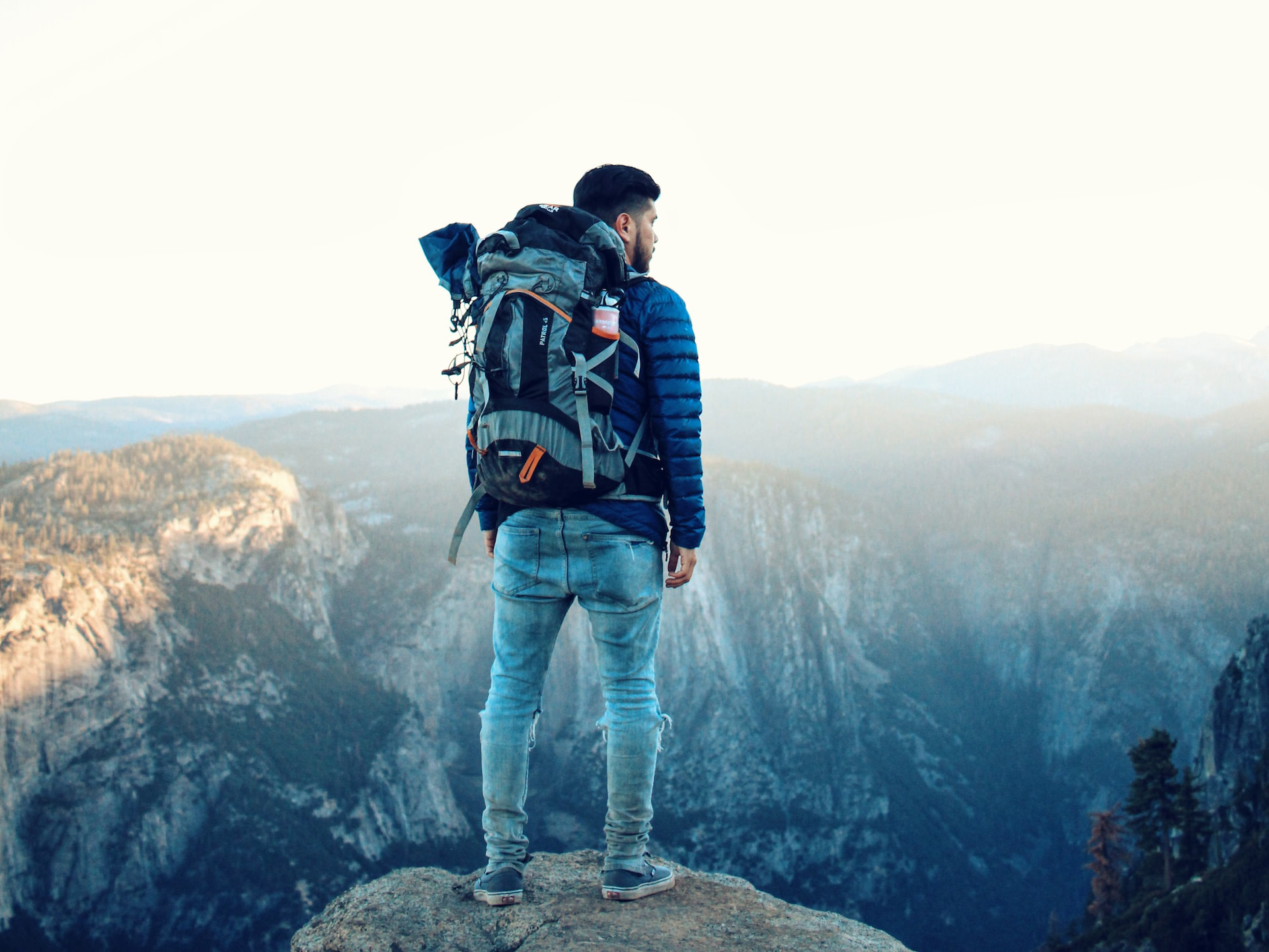 Photograph of a backpacker with in the background mountains